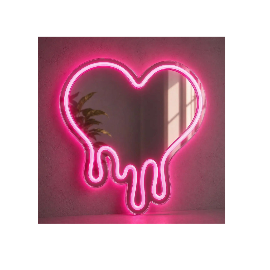 Neon pink heart-shaped light fixture on a white wall